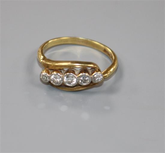 An 18ct gold and platinum, graduated five stone diamond ring, size K.